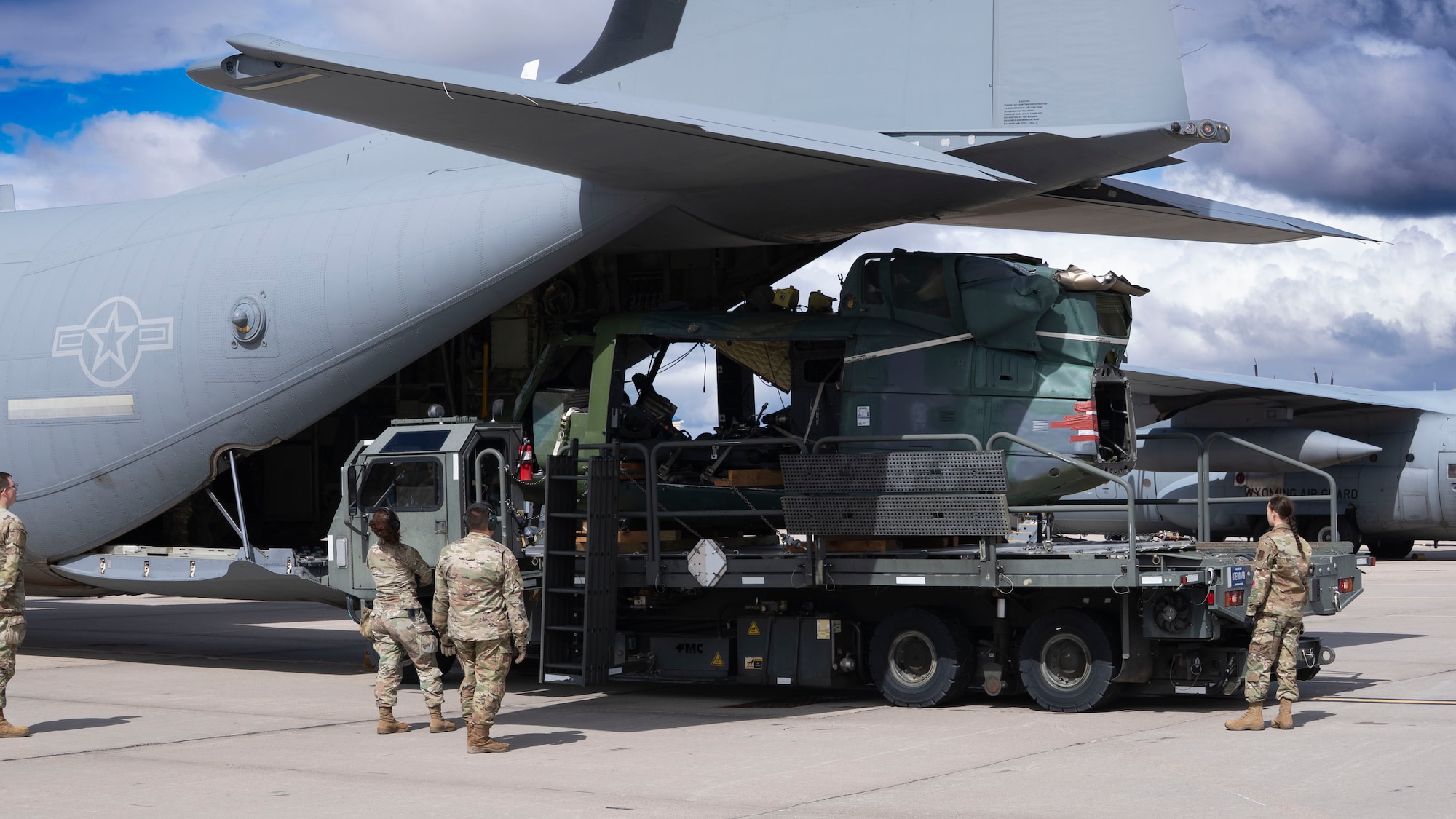 Logisticians from 153rdth Airlift Wing load a UH-1 Iroquois helicopter into a C-130J from Dyess Air Force Base, Texas, at Cheyenne Air National Guard Base, Wyoming, September 17, 2025. The aircraft crashed in 2023 during a training flight and was retrieved for us in the 436th Training Squadron’s Aircraft Mishap Investigation Course Crash Lab. (U.S. Air Force photo by Staff Sgt. Tyrell Hall)