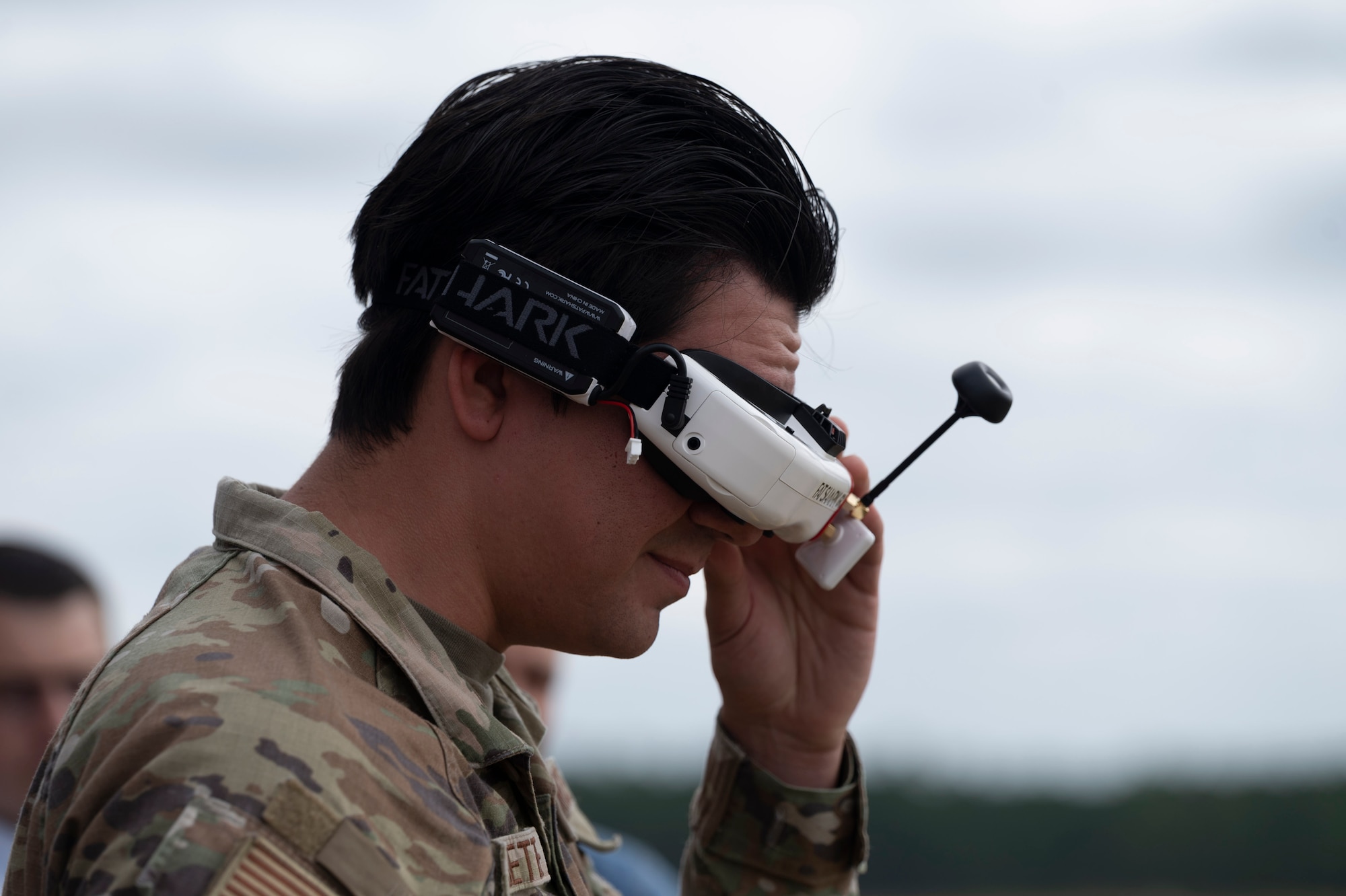 Airman 1st Class Samuel Fredette, a programmer by trade deployed to the Air Forces Central Battle Lab, operates first-person view goggles at Poinsett Electronic Combat Range, Sumter, S.C.  Sept 10, 2025. The goggles are used to control “Nazgul,” a drone that currently holds the local speed record for the AFCENT Battle Lab. (U.S. Air Force photo by Staff Sgt. Moses Taylor)