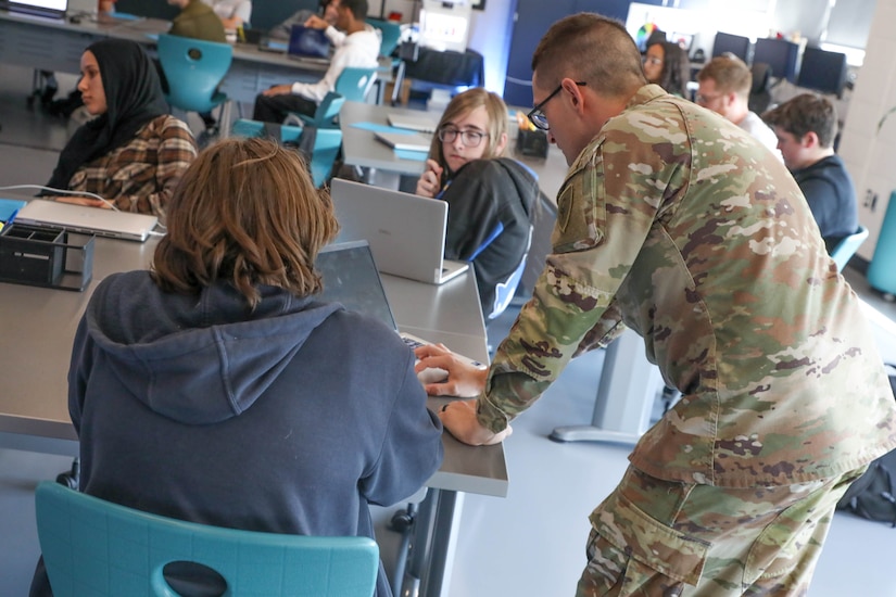 U.S. Army Staff Sgt. Billy Penley helps a student at Fayette County's Hub for Innovative Learning and Leadership in Lexington, Kentucky, Sept. 18, 2025.