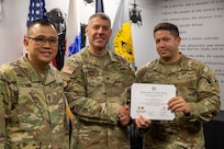 Col. Shaun D. McMurchie, 45th Finance Center director, and Sgt. Maj. Rodani O. Tan, 45th FC senior enlisted advisor, present 1st Lt. Jonathan Padilla, 125th Finance Battalion deputy disbursing officer, with a corticate of training upon completion of the U.S. Army Financial Management Command’s Operational Banking Short Course at the Maj. Gen. Emmett J. Bean Federal Center in Indianapolis Sept. 12, 2025. Upon graduation of the OBSC, Soldiers can advise commanders on establishing financial institutions and ATMs on Army installations, evaluate foreign financial institutions for establishing limited depositary accounts, and provide banking infrastructure evaluations as part of an economic analysis. (U.S. Army photo by Mark R. W. Orders-Woempner)