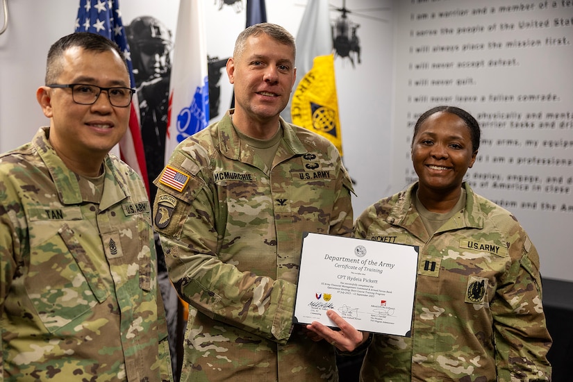 Col. Shaun D. McMurchie, 45th Finance Center director, and Sgt. Maj. Rodani O. Tan, 45th FC senior enlisted advisor, present Capt. Hydeia Pickett, 15th Finance Battalion disbursing officer, with a corticate of training upon completion of the U.S. Army Financial Management Command’s Operational Banking Short Course at the Maj. Gen. Emmett J. Bean Federal Center in Indianapolis Sept. 12, 2025. Upon graduation of the OBSC, Soldiers can advise commanders on establishing financial institutions and ATMs on Army installations, evaluate foreign financial institutions for establishing limited depositary accounts, and provide banking infrastructure evaluations as part of an economic analysis. (U.S. Army photo by Mark R. W. Orders-Woempner)