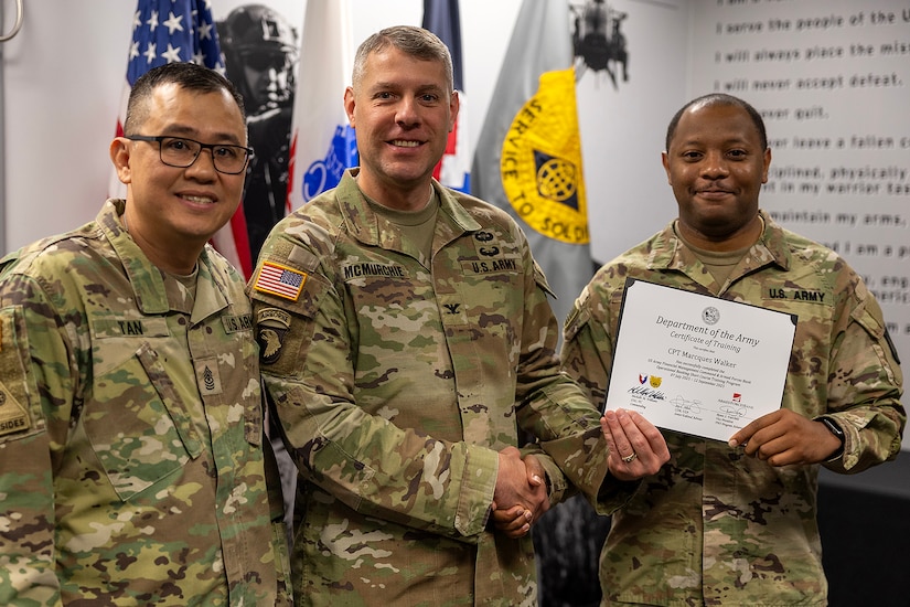 Col. Shaun D. McMurchie, 45th Finance Center director, and Sgt. Maj. Rodani O. Tan, 45th FC senior enlisted advisor, present Capt. Marcques Walker, Tennessee Army National Guard 1128th Finance Company disbursing officer, with a corticate of training upon completion of the U.S. Army Financial Management Command’s Operational Banking Short Course at the Maj. Gen. Emmett J. Bean Federal Center in Indianapolis Sept. 12, 2025. Upon graduation of the OBSC, Soldiers can advise commanders on establishing financial institutions and ATMs on Army installations, evaluate foreign financial institutions for establishing limited depositary accounts, and provide banking infrastructure evaluations as part of an economic analysis. (U.S. Army photo by Mark R. W. Orders-Woempner)