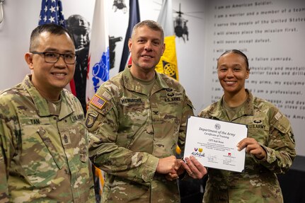 Col. Shaun D. McMurchie, 45th Finance Center director, and Sgt. Maj. Rodani O. Tan, 45th FC senior enlisted advisor, present Capt. Kali Rose, 125th Finance Battalion disbursing officer, with a corticate of training upon completion of the U.S. Army Financial Management Command’s Operational Banking Short Course at the Maj. Gen. Emmett J. Bean Federal Center in Indianapolis Sept. 12, 2025. Upon graduation of the OBSC, Soldiers can advise commanders on establishing financial institutions and ATMs on Army installations, evaluate foreign financial institutions for establishing limited depositary accounts, and provide banking infrastructure evaluations as part of an economic analysis. (U.S. Army photo by Mark R. W. Orders-Woempner)