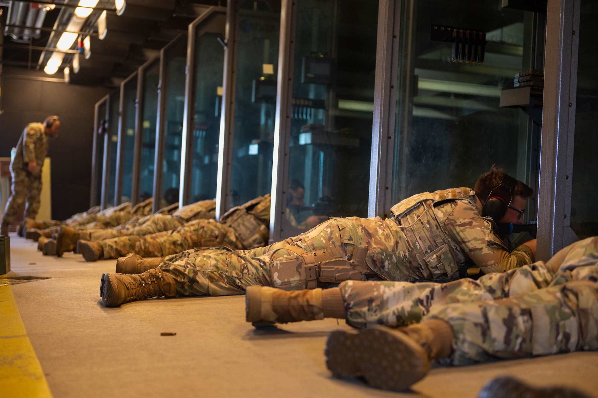 Service members lay down to aim