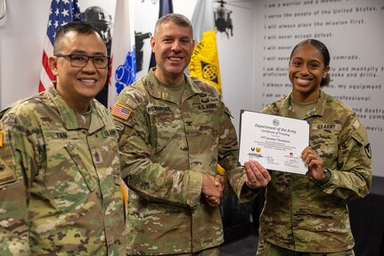 Col. Shaun D. McMurchie, 45th Finance Center director, and Sgt. Maj. Rodani O. Tan, 45th FC senior enlisted advisor, present Capt. Jasmine Thompson, U.S. Army Financial Management Command Department of the Army banking officer; with a corticate of training upon completion of USAFMCOM’s Operational Banking Short Course at the Maj. Gen. Emmett J. Bean Federal Center in Indianapolis Sept. 12, 2025. Upon graduation of the OBSC, Soldiers can advise commanders on establishing financial institutions and ATMs on Army installations, evaluate foreign financial institutions for establishing limited depositary accounts, and provide banking infrastructure evaluations as part of an economic analysis. (U.S. Army photo by Mark R. W. Orders-Woempner)