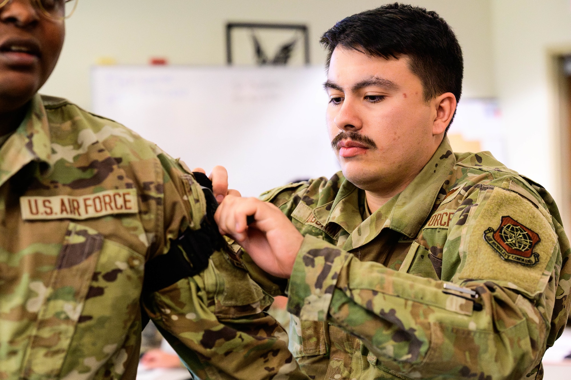 Service member practices placing a tourniquet