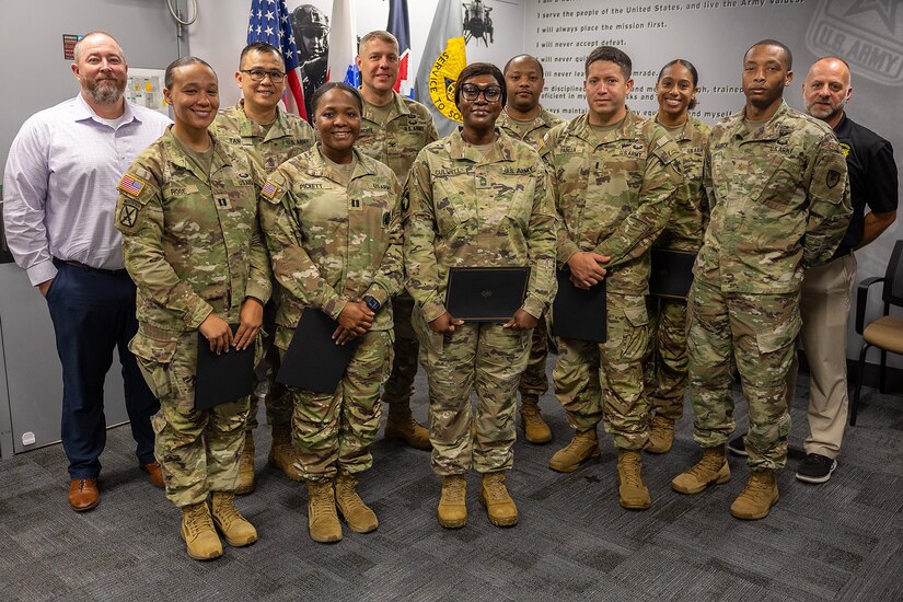 Class 03-25 of the U.S. Army Financial Management Command’s Operational Banking Short Course pose for a photo with USAFMCOM and 45th Finance Center leaders at the Maj. Gen. Emmett J. Bean Federal Center Sept. 12, 2025. Pictured left to right are: Shawn Crocker, USAFMCOM Department of the Army deputy banking officer; Capt. Kali Rose, 125th Finance Battalion disbursing officer; Sgt. Maj. Rodani O. Tan, 45th FC senior enlisted advisor; Capt. Hydeia Pickett, 15th FIBN disbursing officer; Col. Shaun D. McMurchie, 45th FC director; Master Sgt. Toya Culwell, 93rd Finance Battalion senior enlisted advisor; Capt. Marcques Walker, 1128th Finance Company disbursing officer; 1st Lt. Jonathan Padilla, 125th FIBN deputy disbursing officer; Capt. Jasmine Thompson, USAFMCOM Department of the Army banking officer; Maj. Terrell Murdock, USAFMCOM executive officer; and Chad Samsel, USAFMCOM eCommerce and Banking director. (U.S. Army photo by Mark R. W. Orders-Woempner)