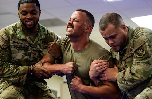 Service members support Airman in pain