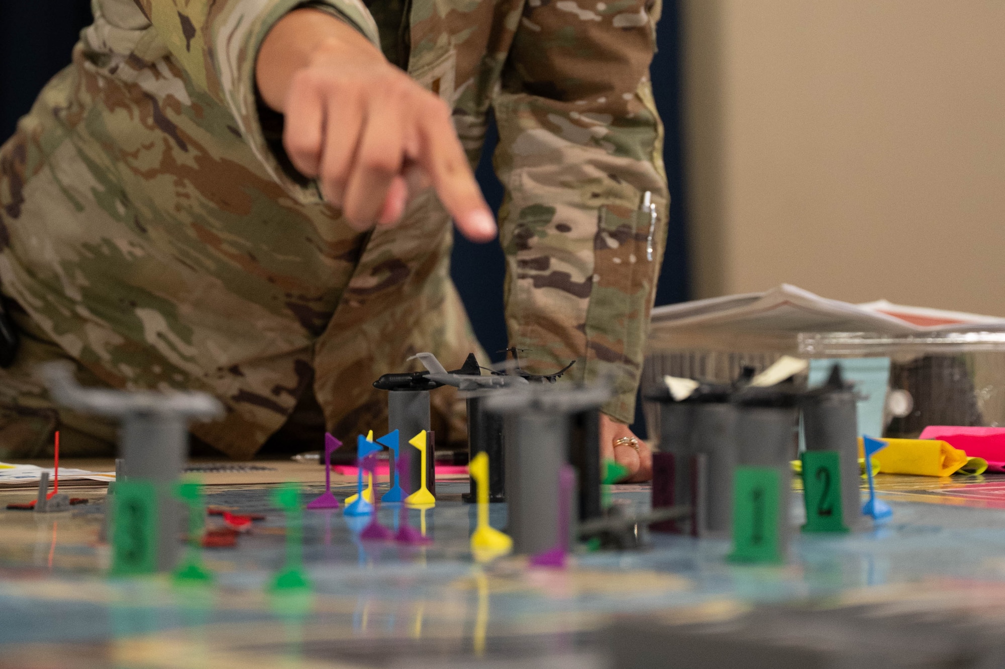Board game pieces are placed in strategic locations during KingFish Agile Combat Employment board wargame exercise at Dyess Air Force Base, Texas, Sept. 16, 2025.  KingFish ACE is designed to be played either on small or large scales with varying amounts of players, and to teach ACE concepts to Airmen staged in contingency scenarios. (U.S. Air Force photo by Airman William Neal)