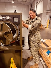 HM2 Nive Hamilton, one of NMRLC's Biomedical Technicians, works on the Automated Field Steam Sterilizer prior to transport to Naval Hospital Guantanamo Bay, Cuba, Sept. 19. Navy Medicine commands and partners responded to an urgent request from GTMO, to deliver critical equipment and expertise.