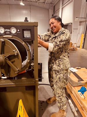 HM2 Nive Hamilton, one of NMRLC's Biomedical Technicians, works on the Automated Field Steam Sterilizer prior to transport to Naval Hospital Guantanamo Bay, Cuba, Sept. 19. Navy Medicine commands and partners responded to an urgent request from GTMO, to deliver critical equipment and expertise.