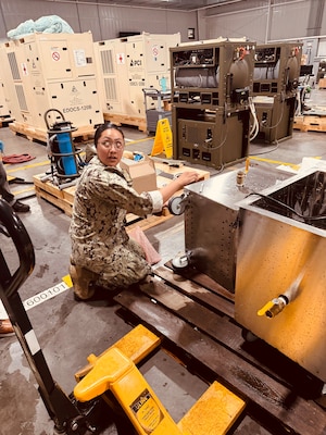 HM2 Nive Hamilton, an NMRLC Biomedical Technician, works on one of two Ultrasonic Portable Washers that were transported to Naval Hospital Guantanamo Bay, Cuba, Sept. 19. Navy Medicine commands and partners responded to an urgent request to deliver critical equipment and expertise on short notice.