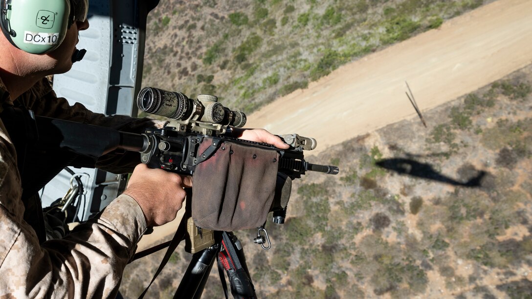 U.S. Marine Corps Sgt. Daniel Rusco, a reconnaissance Marine with the Maritime Raid Force, 11th Marine Expeditionary Unit, rides in a U.S. Army UH-60 Black Hawk assigned to Bravo Company, 1-140th Aviation Regiment, during Advanced Sniper Course 25-2 hosted by Expeditionary Operations Training Group, I Marine Expeditionary Force, on Marine Corps Base Camp Pendleton, California, Sept. 19, 2025. ASC is designed to train personnel in the marksmanship skills necessary to provide sniper support to expeditionary operations. (U.S. Marine Corps photo by Cpl. Oliver Nisbet)