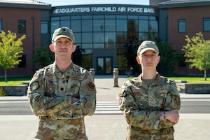 2 people in military uniform in front of HQ building