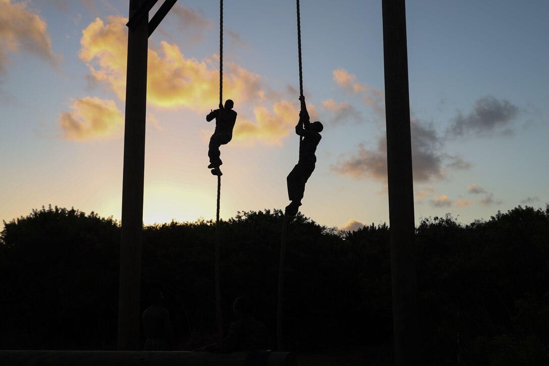 U.S. Marines with Marine Aircraft Group 24, 1st Marine Aircraft Wing, climb the obstacle course ropes during a physical training event at Marine Corps Base Hawaii, Aug. 27, 2025. The training included ground fighting techniques and an obstacle course designed to enhance combat readiness, build physical resilience, and challenge mental fortitude. (U.S. Marine Corps photo by Cpl. Anabelle C. Reed-O’Brien)