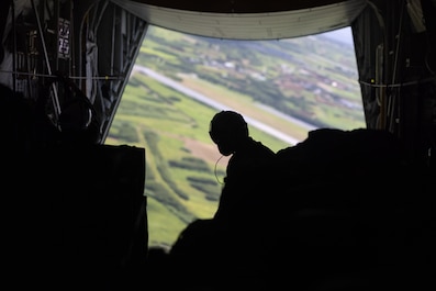 OKINAWA, Japan (Sept. 23, 2025) — U.S. Marine Corps Cpl. Devin McRae, a loadmaster with Marine Aerial Refueler Transport Squadron 153, Marine Aircraft Group 24, 1st Marine Aircraft Wing, waits for arrival at a drop zone before releasing container...