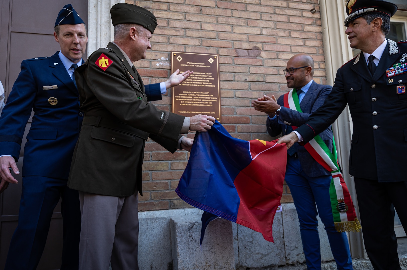 Oklahoma National Guard leaders and Italian representatives unveil a plaque at the former headquarters of the 45th Infantry Division during WWII in Venafro, Italy, Sept. 8, 2025. A delegation of Oklahoma National Guard members and veterans toured key locations from the 45th Infantry Division’s campaign in Italy against German forces during World War II, continuing the development of the Thunderbird Trail. The initiative is aimed at preserving the Division's role in World War II through a memorial trail tracing its footsteps through Italy, France and Germany, ensuring their sacrifices are never forgotten. (U.S. Army photo by Sgt. Danielle Rayon)