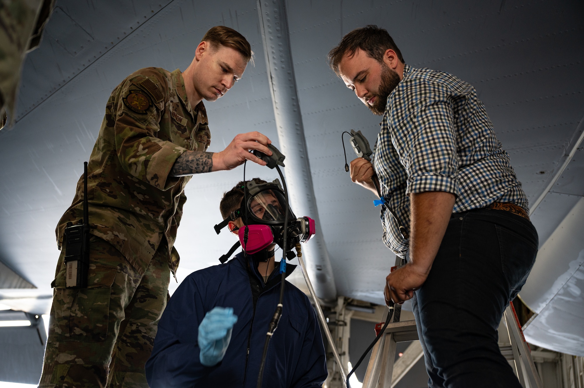 From left, U.S. Air Force Tech. Sgt. Jubal Johnson and Airman 1st Class William Brice, 100th Maintenance Squadron, and Alex Motz, software technician, prepare the Integrated Respirator Information System for a demonstration at RAF Mildenhall, England, Sept. 2, 2025.
