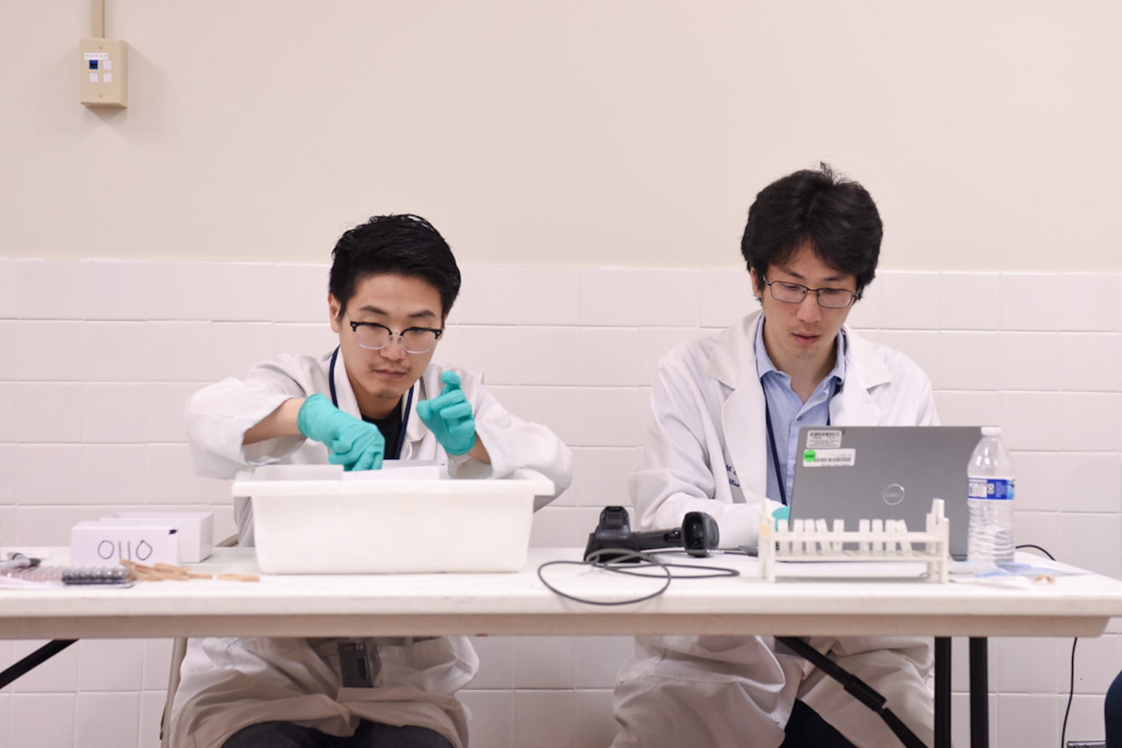 Image of two people working with samples.