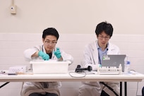 Image of two people working with samples.