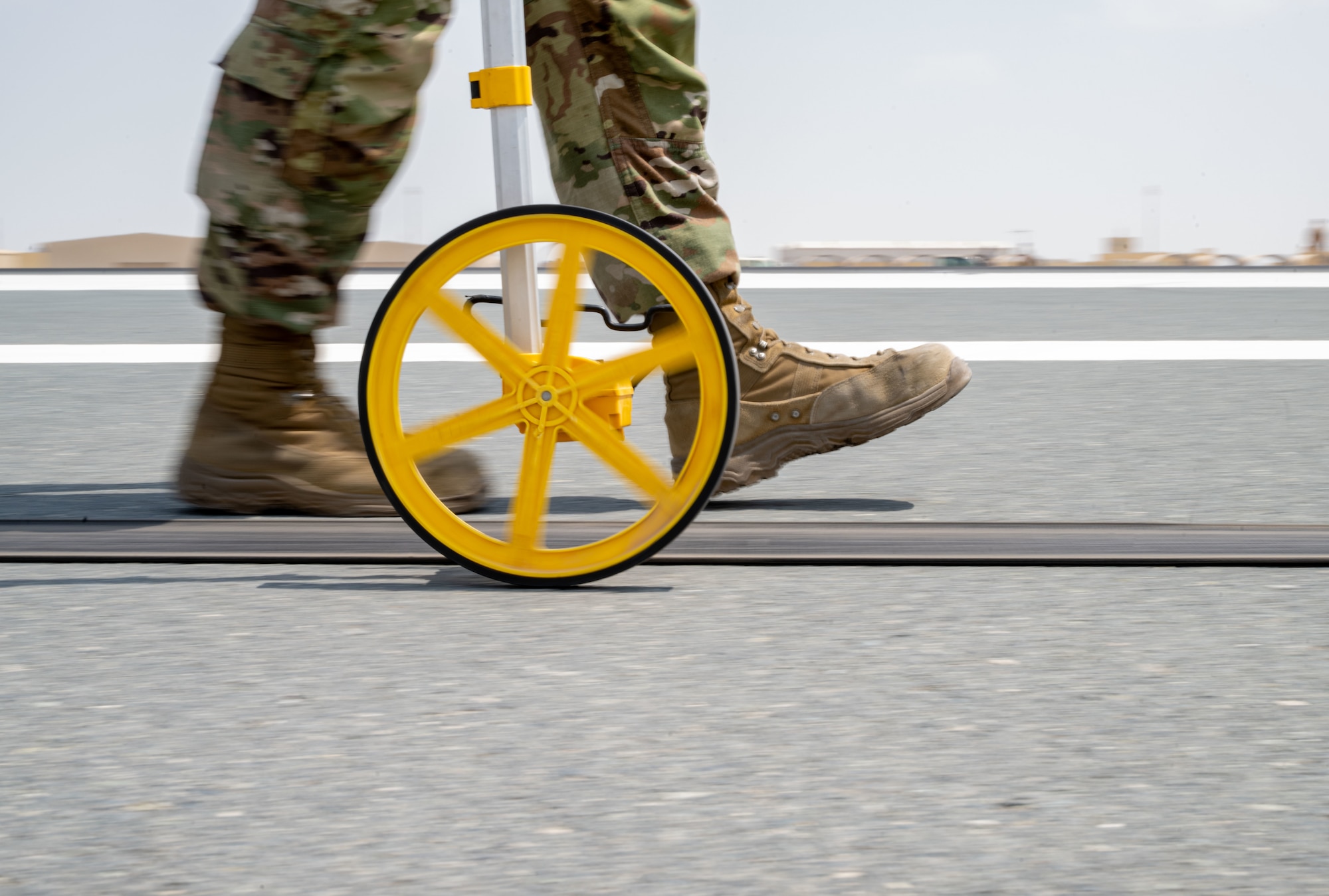 U.S. Air Force Staff Sgt. Joseph Clower, 379th Expeditionary Civil Engineer Squadron barrier maintenance technician, takes measurements after an arresting system test within the U.S. Central Command area of responsibility, Sept. 14, 2025. The test followed a 10-year overhaul of the system, completed through a joint effort by the 379th ECES Barrier Maintenance and Heavy Equipment sections. (U.S. Air Force photo by Senior Airman Amanda Jett)