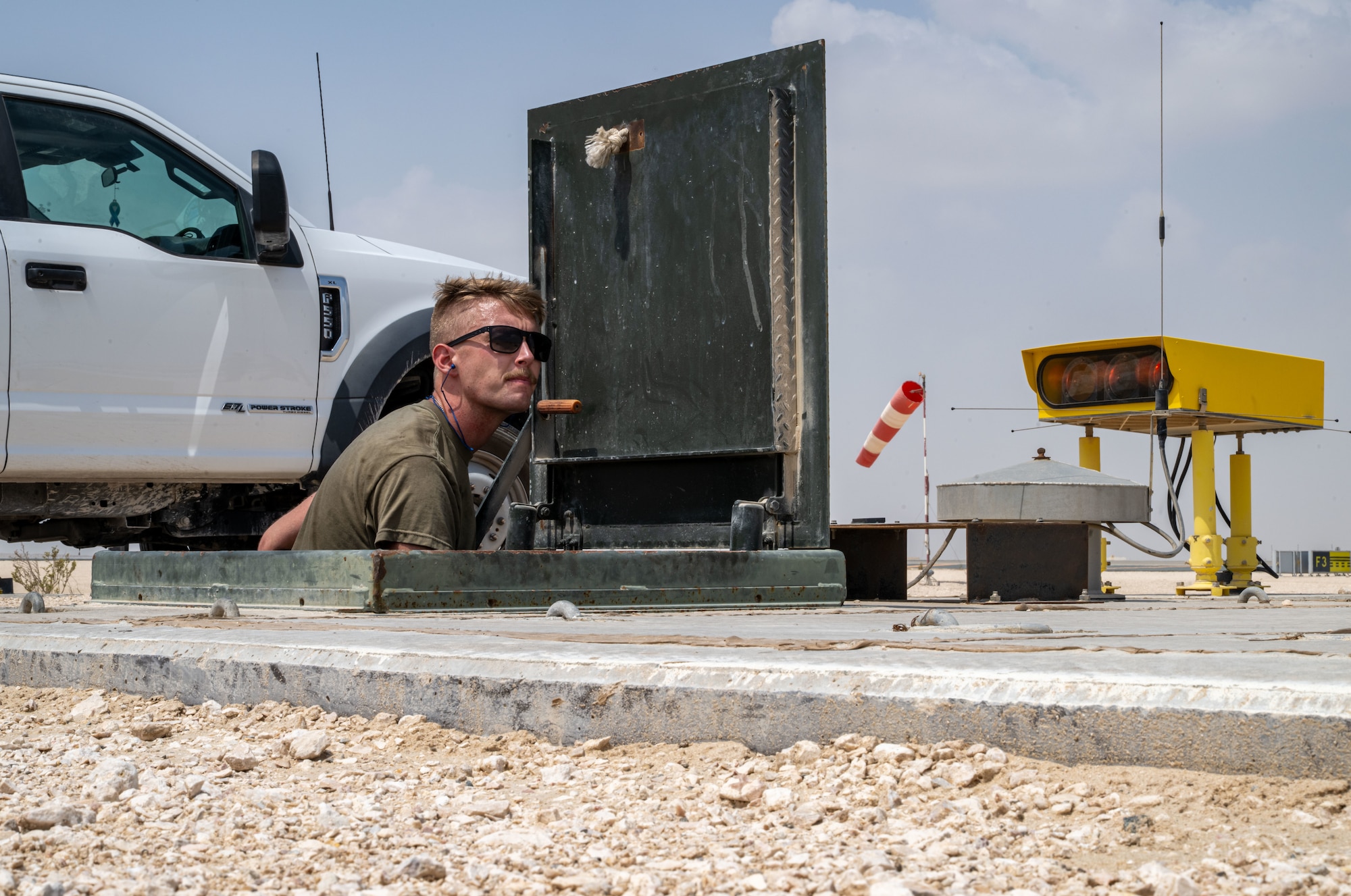 U.S. Air Force Staff Sgt. Joseph Peterson 379th Expeditionary Civil Engineer Squadron barrier maintenance technician, resets a barrier arresting system within the U.S. Central Command area of responsibility, Sept. 14, 2025. The test followed a 10-year overhaul of the system, completed through a joint effort by the 379th ECES Barrier Maintenance and Heavy Equipment sections. (U.S. Air Force photo by Senior Airman Amanda Jett)