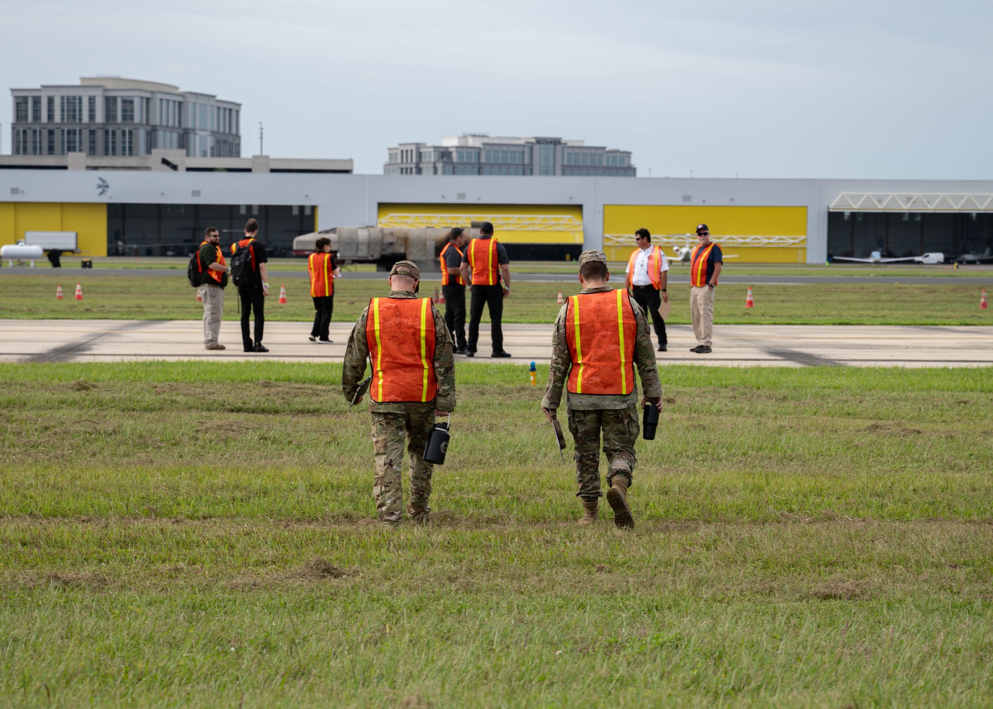 U.S. Air Force Lt. Col. Paul Seal, 6th Air Refueling Wing chief of safety, left, and Tech. Sgt. Adam Serdynski, 6th ARW flight safety non-commissioned officer, right, walk out to the flight line during the 2025 Triennial "Double Trouble" emergency response exercise at Tampa International Airport, Sept. 17, 2025. The flight safety team provided oversight alongside civilian agencies during a simulated aircraft emergency. (U.S. Air Force photo by Airman 1st Class Monique Stober)