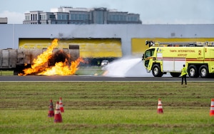 Firefighting crews from Tampa International Airport respond to a simulated aircraft fire during the 2025 Triennial "Double Trouble" emergency response exercise at TPA, Sept. 17, 2025. The exercise tested joint emergency response procedures and interoperability between civilian and military agencies during simulated aviation incidents. (U.S. Air Force photo by Airman 1st Class Monique Stober)
