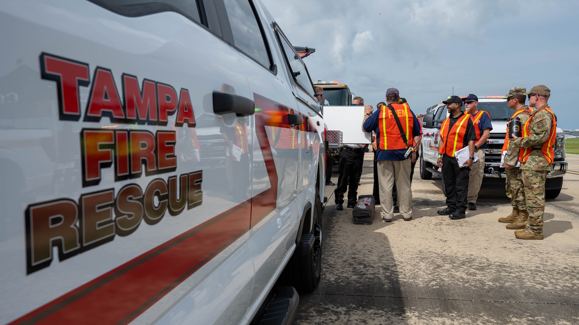 Members of Tampa Fire Rescue and Airmen assigned to the 6th Air Refueling Wing safety office, go over lessons learned after completing the 2025 Triennial "Double Trouble" emergency response exercise at Tampa International Airport, Sept. 17, 2025. The exercise tested joint emergency response procedures and interoperability between civilian and military agencies during simulated aviation incidents. (U.S. Air Force photo by Airman 1st Class Monique Stober)