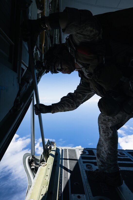 A U.S. Marine with Force Reconnaissance Platoon, Maritime Raid Force, 31st Marine Expeditionary Unit, conducts spotting procedures during parachute operations training over Okinawa, Japan, Sep. 26, 2025. The Marines conducted the training to maintain and improve their parachute insertion skills. The 31st MEU, the Marine Corps’ only continuously forward-deployed MEU, provides a flexible and lethal force ready to perform a wide range of military operations as the premiere crisis response force in the Indo-Pacific region. (U.S. Marine Corps photo by Cpl. Alora Finigan)