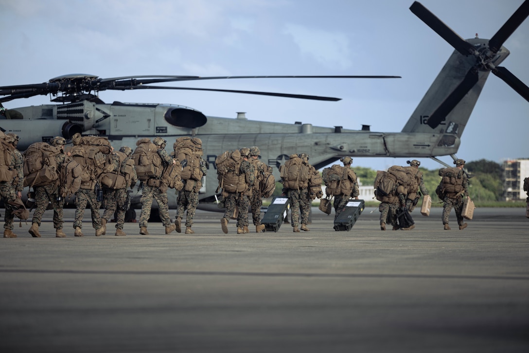 U.S. Marines with Battalion Landing Team 1st Battalion, 7th Marine Regiment, 31st Marine Expeditionary Unit, load onto a U.S. Marine Corps CH53-E Super Stallion assigned to Marine Medium Tiltrotor Squadron (VMM) 265 (Rein.), 31st MEU, during flight operations at Marine Corps Air Station Futenma, Okinawa, Japan, Sept. 26, 2025. The Marines conducted flight operations demonstrating multi-domain transport capabilities to support combined-joint all domain operations. The 31st MEU, the Marine Corps’ only continuously forward-deployed MEU, provides a flexible and lethal force, ready to perform a wide range of military operations as the premiere crisis response force in the Indo-Pacific region. (U.S. Marine Corps photo by Sgt. Angel Diaz Montes De Oca)