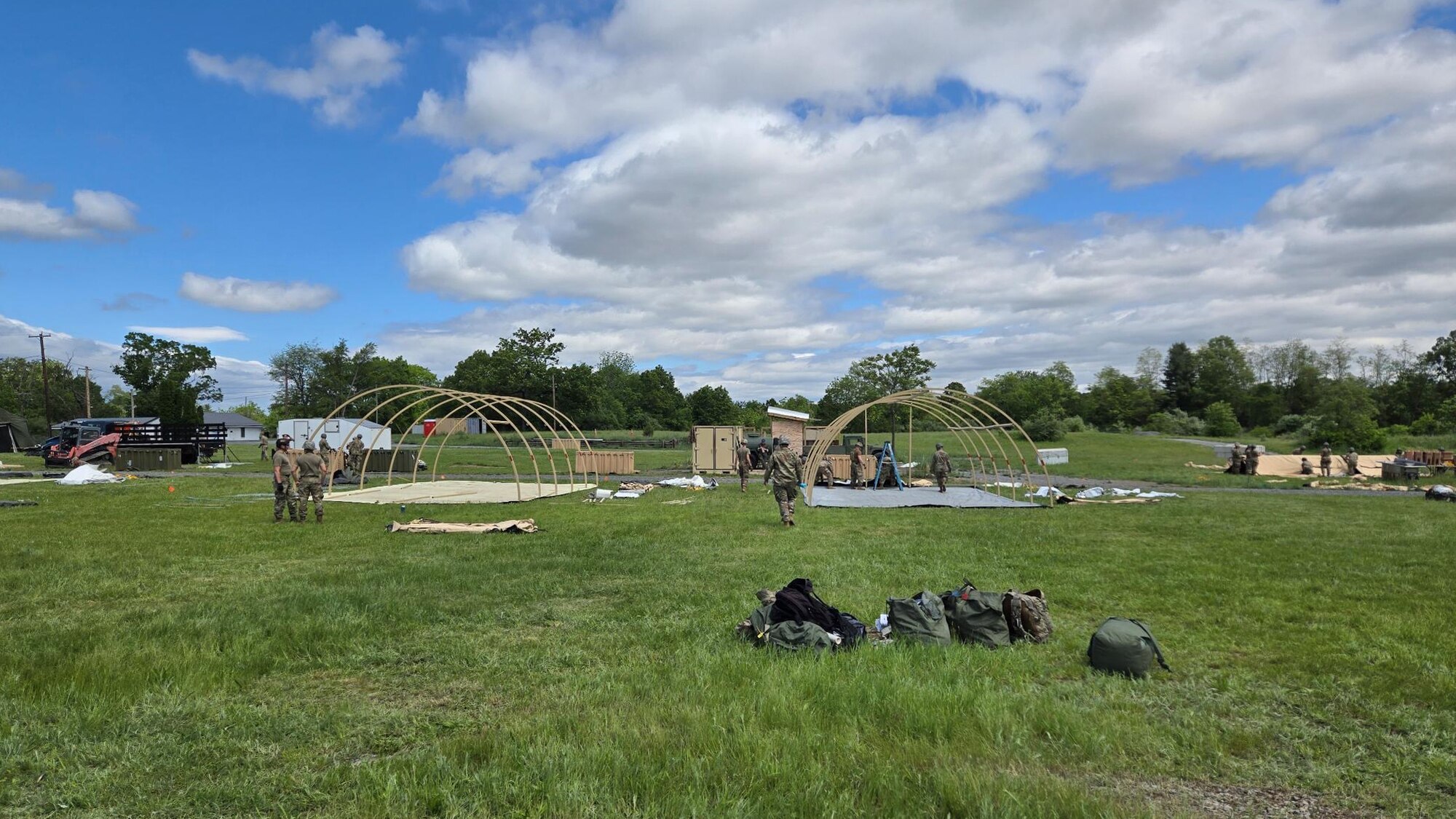Airmen from the Kentucky Air National Guard’s 123rd Mission Support Group erect Small Shelter System tents in Indiantown Gap, Pa., May 22, 2025, as part of Exercise Kentucky Windage 2025. Nearly 70 Airmen deployed for the field exercise to strengthen their Agile Combat Employment skills. (U.S. Air National Guard photo by Master Sgt. Kenneth Soto)