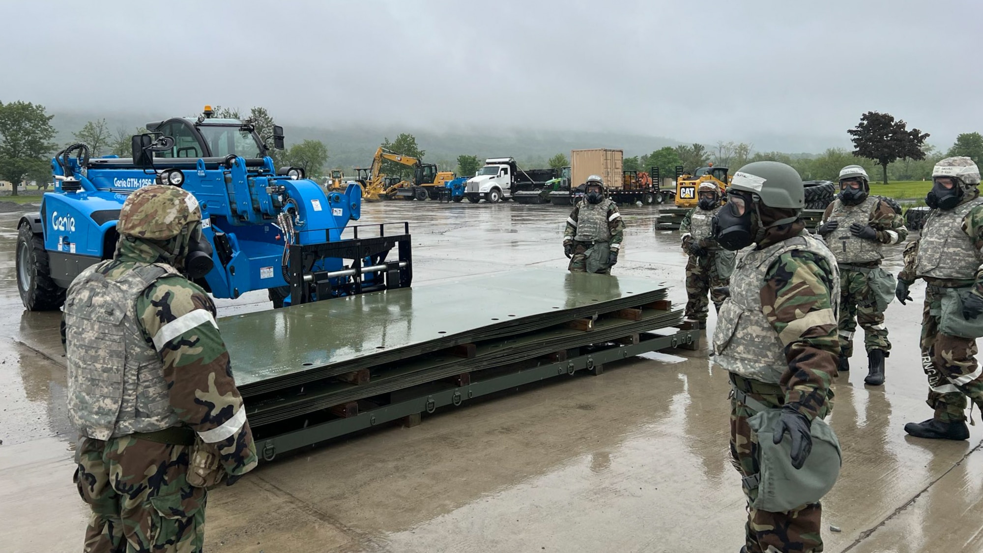 Airmen from the Kentucky Air National Guard’s 123rd Mission Support Group conduct operations while wearing chemical warfare ensembles in Indiantown Gap, Pa., May 22, 2025, as part of Exercise Kentucky Windage 2025. Nearly 70 Airmen deployed for the field exercise to strengthen their Agile Combat Employment skills. (U.S. Air National Guard photo by Master Sgt. Kenneth Soto)