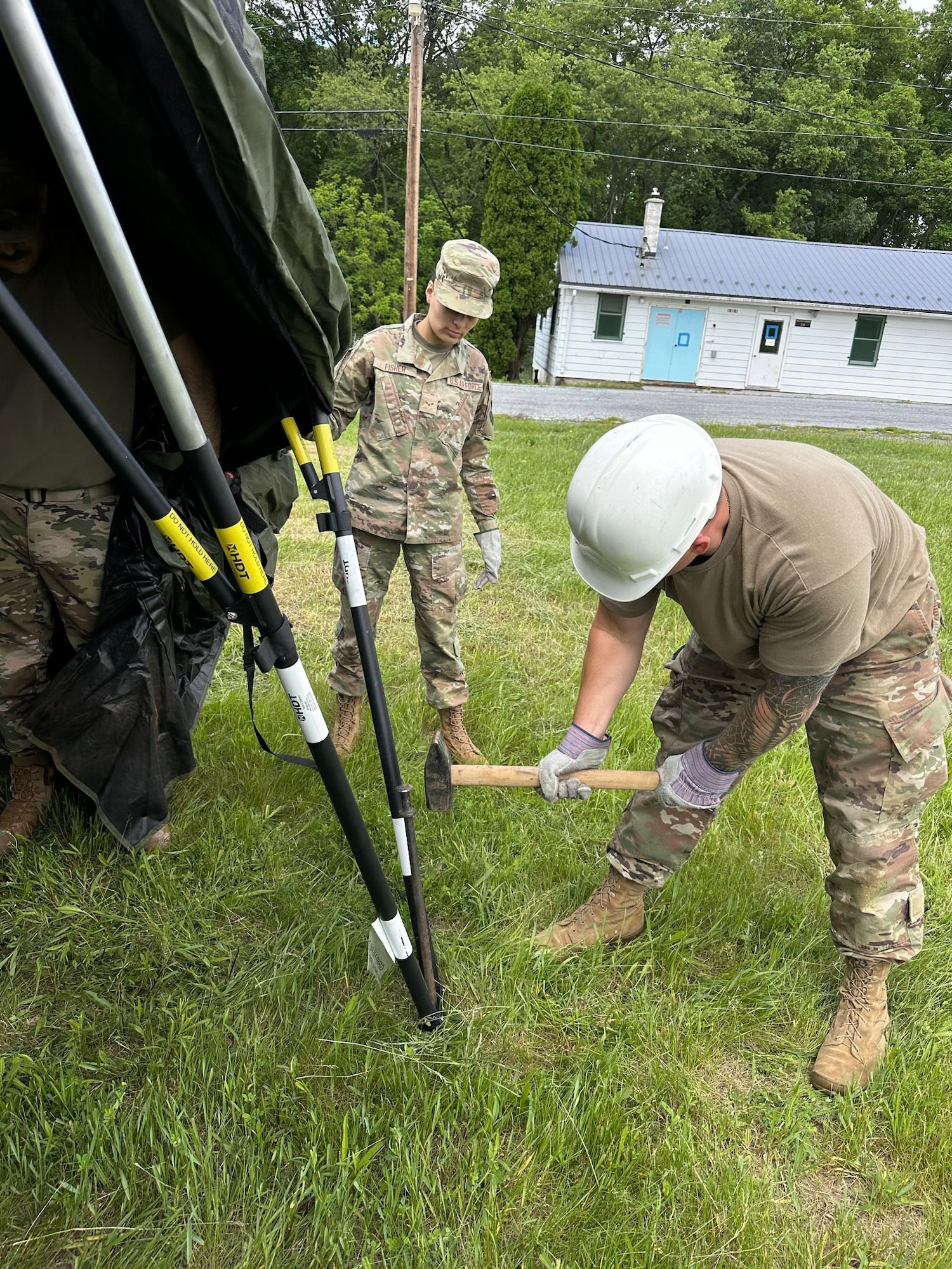 Airmen from the Kentucky Air National Guard’s 123rd Mission Support Group erect tent frames in Indiantown Gap, Pa., May 22, 2025, as part of Exercise Kentucky Windage 2025. Nearly 70 Airmen deployed for the field exercise to strengthen their Agile Combat Employment skills. (U.S. Air National Guard photo by Master Sgt. Kenneth Soto)