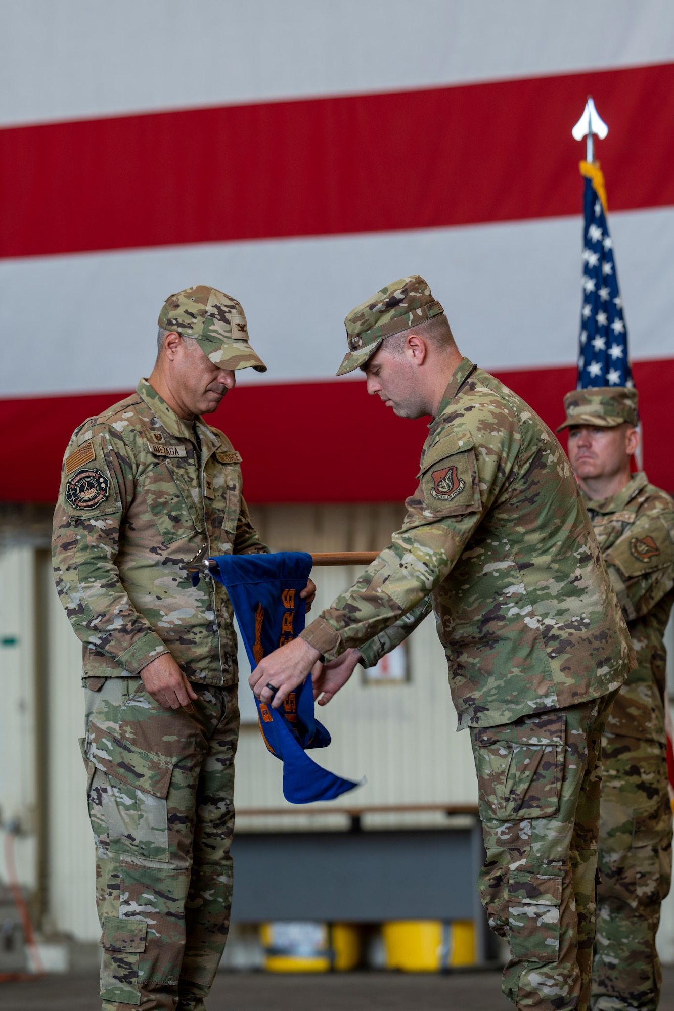 Two men grasp a flag.