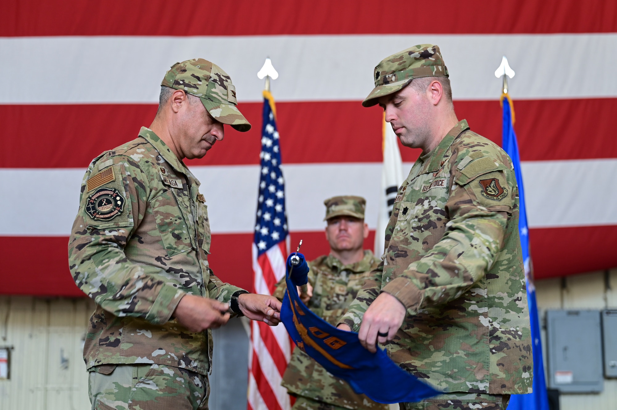 Two men grasp a flag.