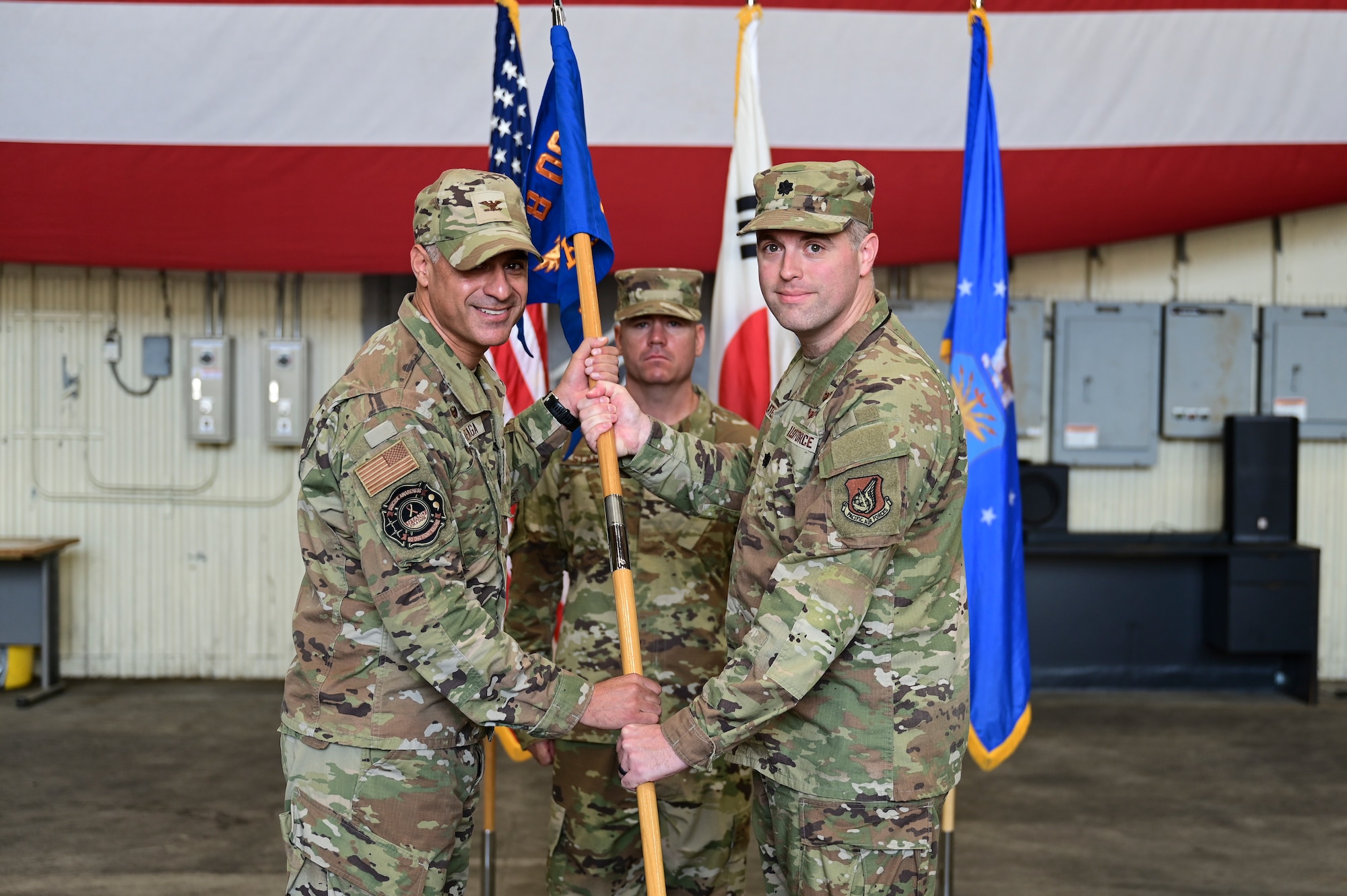 Two men grasp a flag.