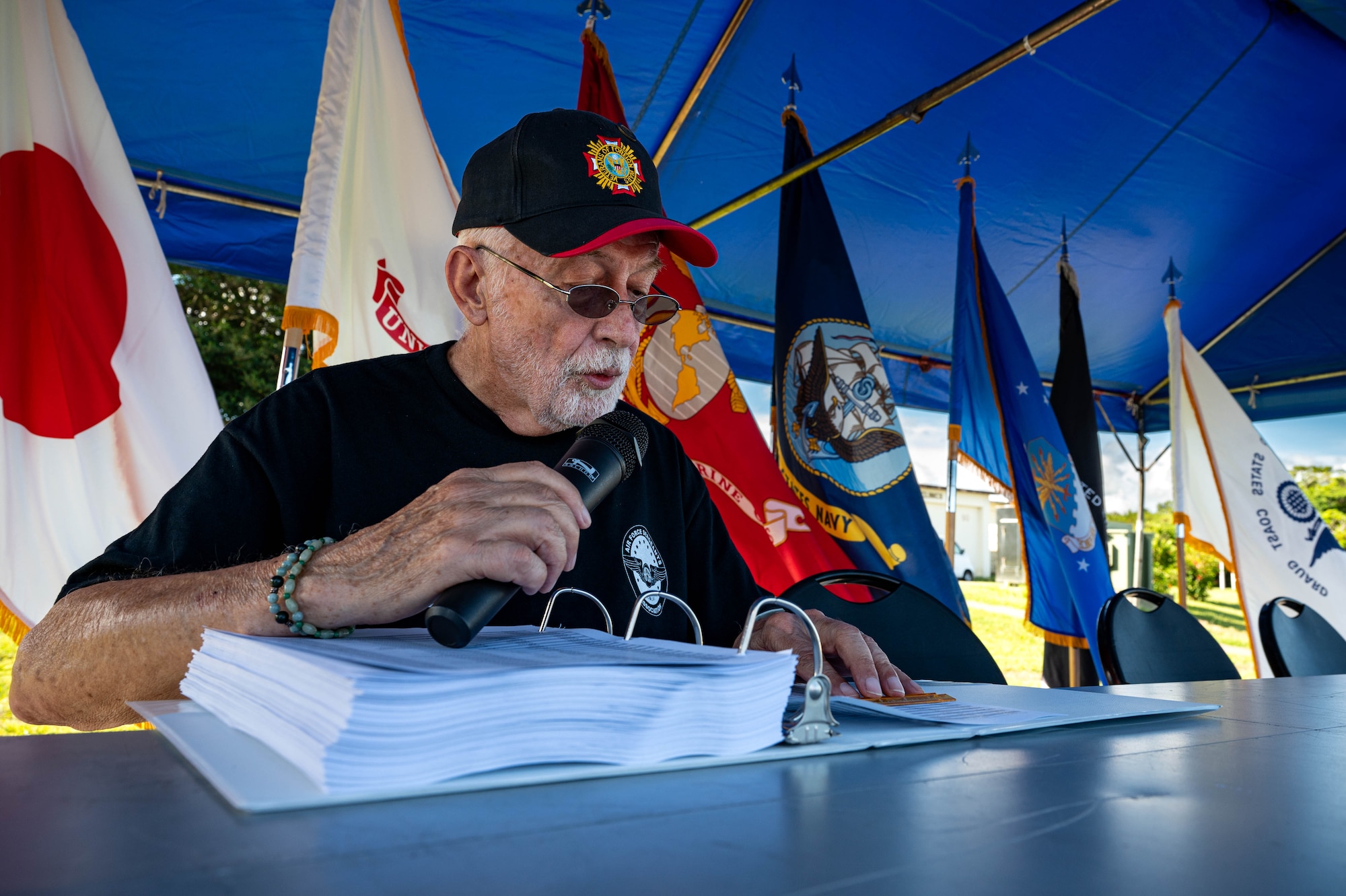 Curt Kozlesky, U.S. Marine Corps Chief Warrant Officer (Ret.), reads from a list of names of all known prisoners of war and missing in action personnel during the opening ceremony of the POW/MIA Remembrance Run 24-hour ruck at Kadena Air Base, Japan, Sept. 18, 2025. The Department of Defense remembers and honors those Americans who were prisoners of war and those who served and never returned home. (U.S. Air Force photo by Airman Nathaniel Jackson)