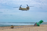 Connecticut Army National Guard Staff Sgt. Frank Perrotti, left, and Connecticut Army National Guard Sgt. 1st Class Richard Wooten, right, crew chiefs assigned to the 1109th Theater Aviation Support Maintenance Group, prepare to attach a sling to a Connecticut Army National Guard CH-47F Chinook helicopter during a buoy recovery mission, Nantucket, Massachusetts, Sept. 8, 2025. Due to the buoy’s weight of approximately 13,000 pounds, the sling was attached to the aircraft’s center hook which is capable of carrying a load up to 26,000 lb.