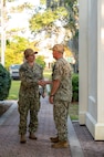 Leadership greet each other outside of a building before the start of a tour