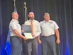 Coast Guard Petty Officer First Class Michael Mealey (ret.) and Chief Petty Officer Chad Cruset represent Port Security Unit (PSU) 309 at the 2024 DoW Suicide Prevention Recognition Ceremony held at the Pentagon on September 4, 2025. Rear Admiral Shane Steiner, Acting Assistant Commandant for Workforce and Family Services, presented certificates and coins to PSU 309 and members from Sector Northern New England (not pictured) recognizing their outstanding work in suicide prevention.