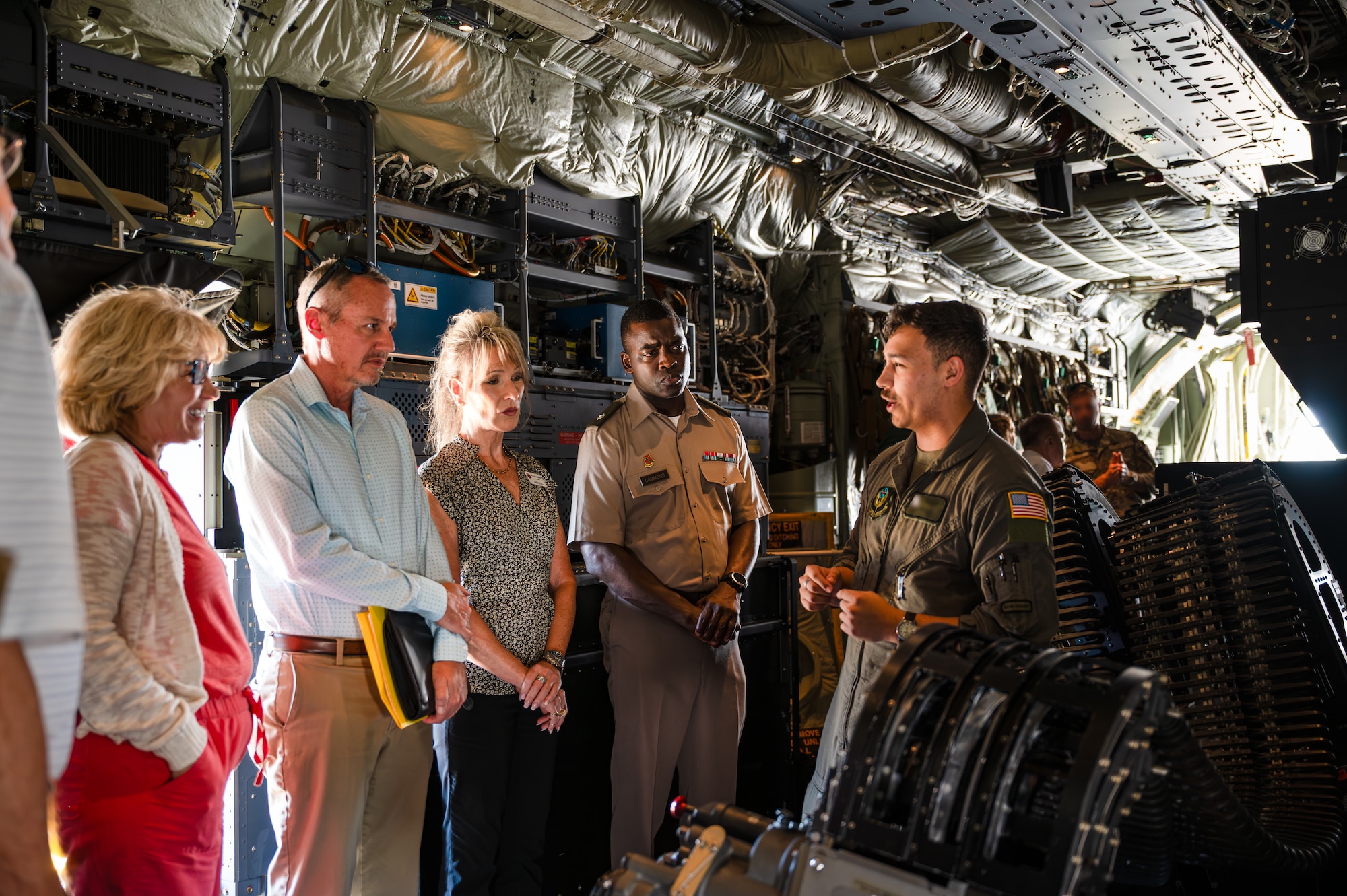 A group from the FDSC get a briefing of the 30 mm autocannon inside of an AC-130J Ghostrider gunship.