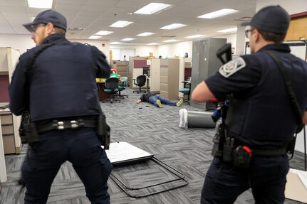 Responding police officers, assigned to the Arlington Heights Police Department, take down an active shooter role player, during an active shooter training exercise at the 85th U.S. Army Reserve Support Command headquarters, September 6, 2025.