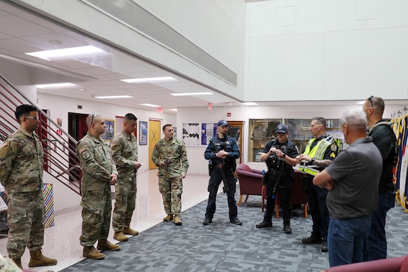 Sgt. Patrick Chojnowski, in yellow vest, a sergeant assigned to the Arlington Heights Police Department, gives a safety brief to members of the 85th U.S. Army Reserve Support Command during an active shooter training exercise at the 85th USARSC headquarters, September 6, 2025.