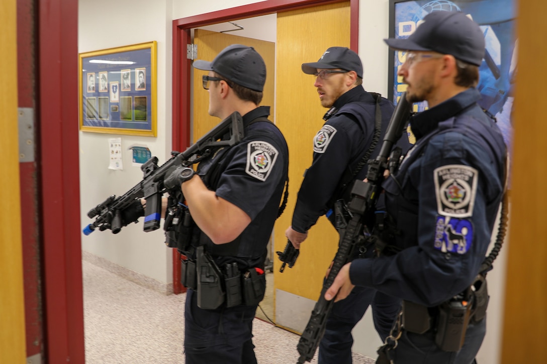 Police officers, assigned to the Arlington Heights Police Department, move through a building during an active shooter training exercise at the 85th U.S. Army Reserve Support Command headquarters, September 6, 2025.