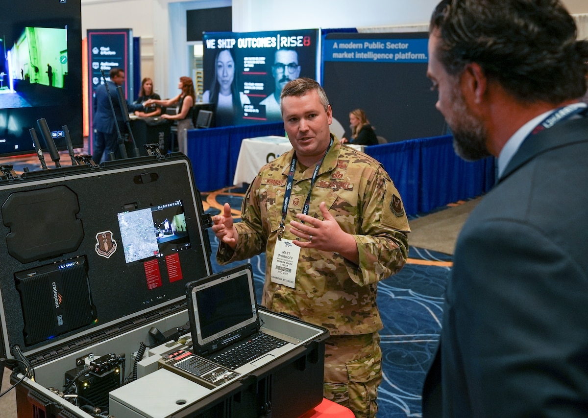 Master Sgt. Matt Workoff, AFWERX Spark, briefs Matthew Lohmeier, Under Secretary of the Air Force, during the Air, Space and Cyber Conference at the Gaylord National Resort and Convention Center in National Harbor, Maryland, on Sept. 23, 2025.