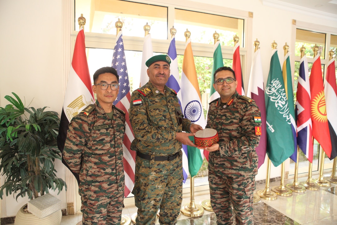 Yemeni Maj. Gen. Ismail Zahzouh, commander of Special Operations Forces, center, exchanges gifts with a senior Indian officer during Exercise Bright Star 2025 at Mohamed Naguib Military Base, Sept. 7, 2025. Bright Star 2025 is a multilateral U.S. Central Command exercise co-hosted with Egypt across air, land and sea domains. The exercise promotes regional security and cooperation and improves interoperability in irregular warfare against hybrid threats, with more than 40 countries participating this year. (U.S. Central Command photo by Maged Benjamin-Elias)