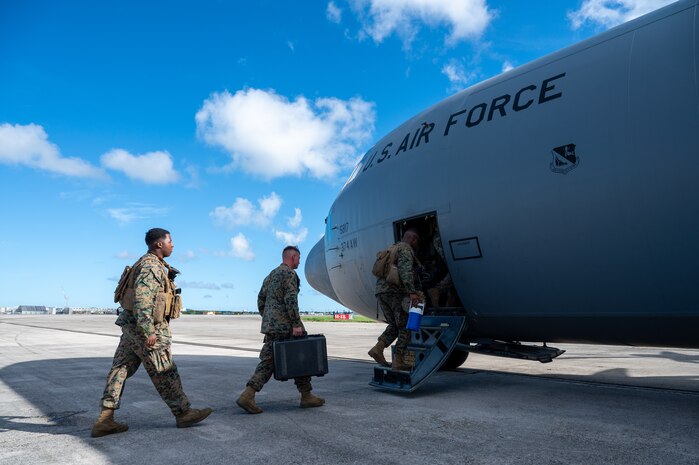U.S. Marines board a U.S. Air Force C-130J Super Hercules assigned to the 36th Airlift Squadron during a High Mobility Artillery Rocket System Rapid Insertion training at Kadena Air Base, Japan, Sept. 19, 2025. Yokota Airmen regularly conduct training events with joint partners to build interoperability and strengthen capabilities in support of a free and open Indo-Pacific. (U.S. Air Force photo by Staff Sgt. Natalie Doan)