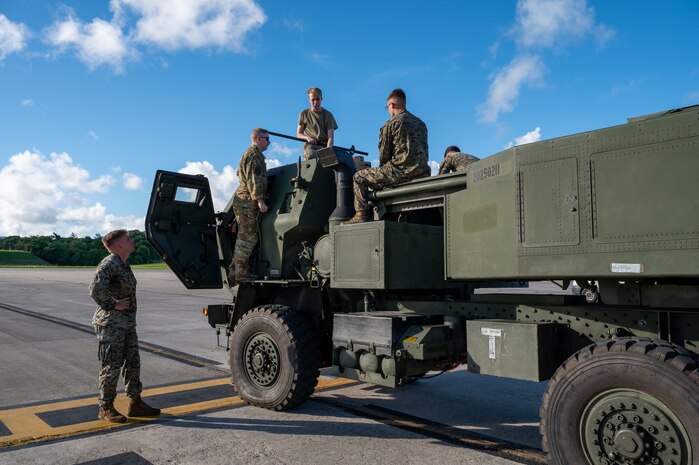 U.S. Marines and U.S. Air Force Airmen prepare to load a High Mobility Artillery Rocket System into a C-130J Super Hercules assigned to the 36th Airlift Squadron during a HIMARS Rapid Insertion training at Kadena Air Base, Japan, Sept. 19, 2025. Yokota Airmen regularly conduct training events with joint partners to build interoperability and strengthen capabilities in support of a free and open Indo-Pacific. (U.S. Air Force photo by Staff Sgt. Natalie Doan)