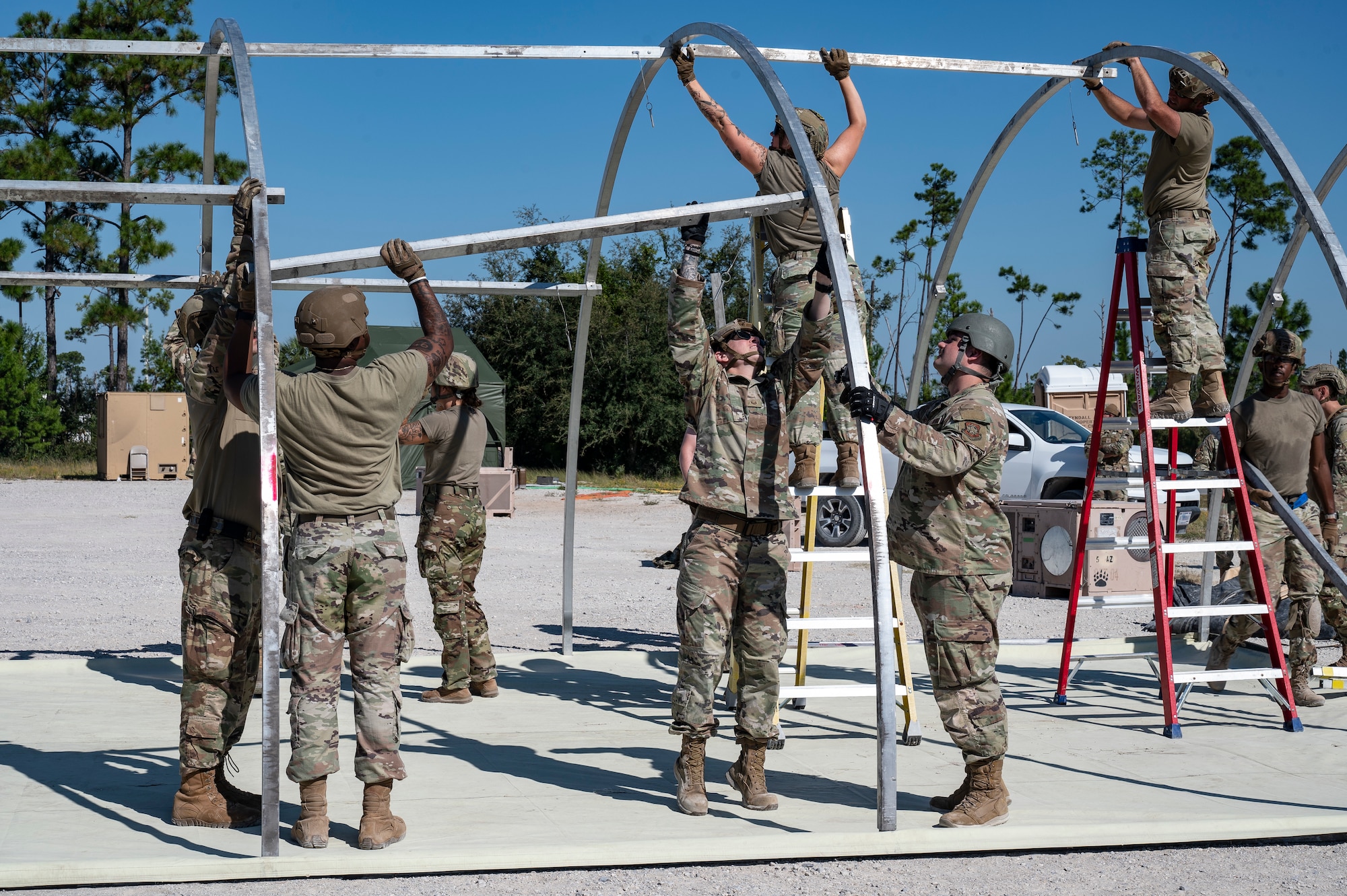 U.S. Air Force Lt. Col. Benjamin Muse, 723rd Combat Air Base Squadron (CABS) commander, and Senior Master Sgt. Tiana Wadlington, 723rd CABS first sergeant, unveil the unit’s new guidon at the Silver Flag Exercise Site on Tyndall Air Force Base, Fla., Sept. 15, 2025. After the deactivation of the 23rd CABS, a new guidon was created and presented for the activation of the 723rd CABS.